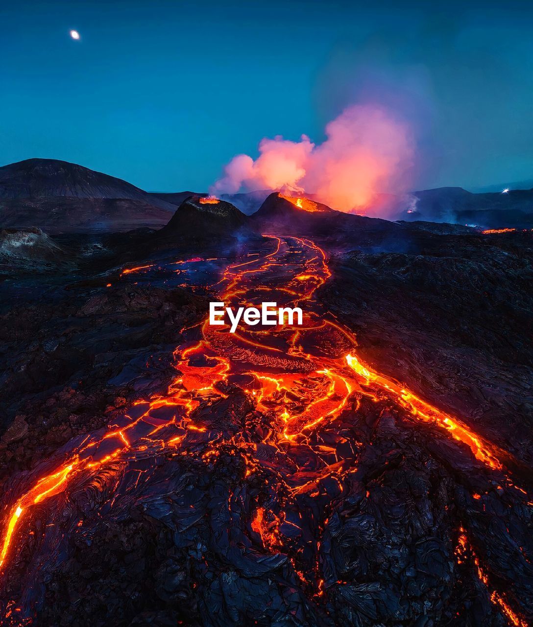 Light trails on illuminated mountain at night