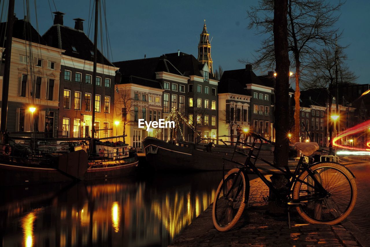 VIEW OF ILLUMINATED BUILDINGS BY CANAL