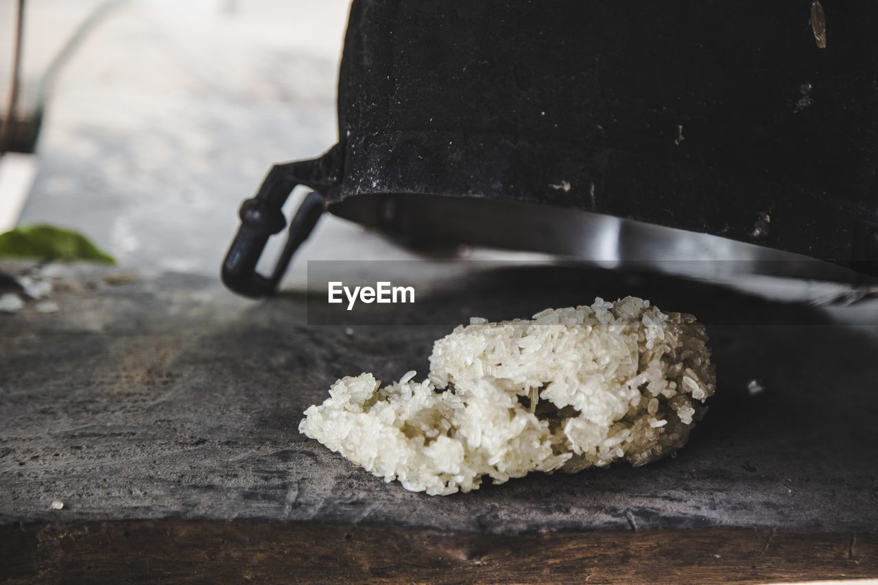 Sticky rice on table covered with container