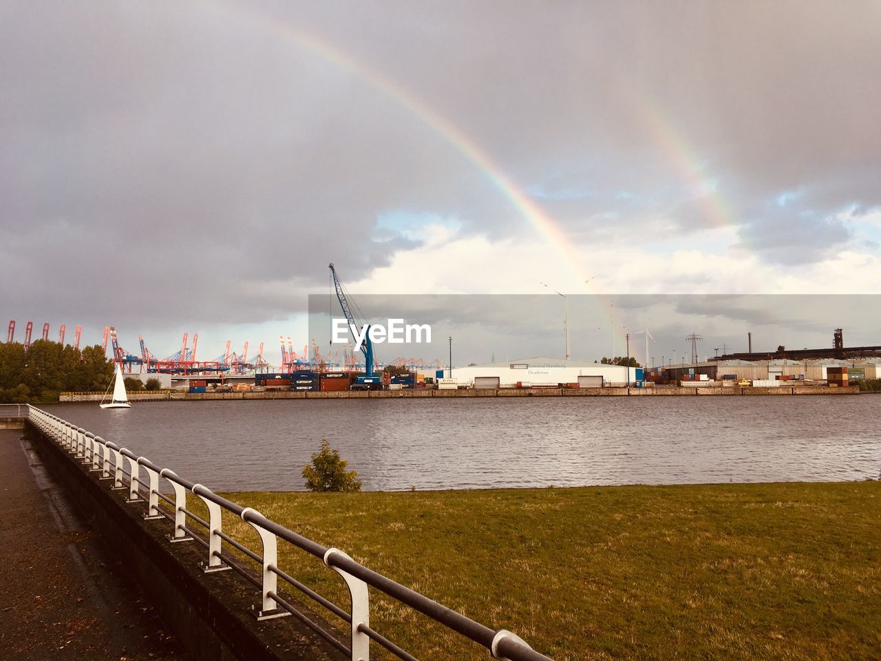 VIEW OF RAINBOW OVER RIVER AGAINST SKY