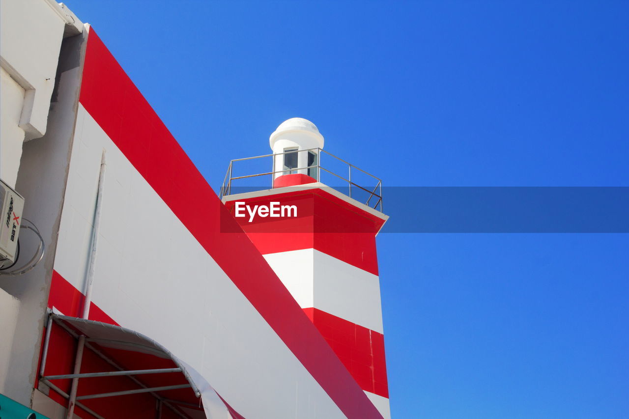 Low angle view of building against clear blue sky