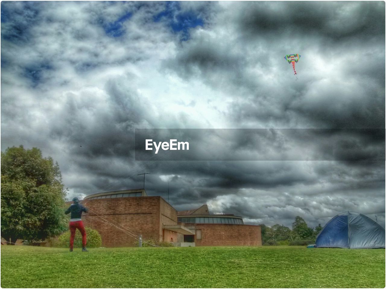 VIEW OF FIELD AGAINST CLOUDY SKY