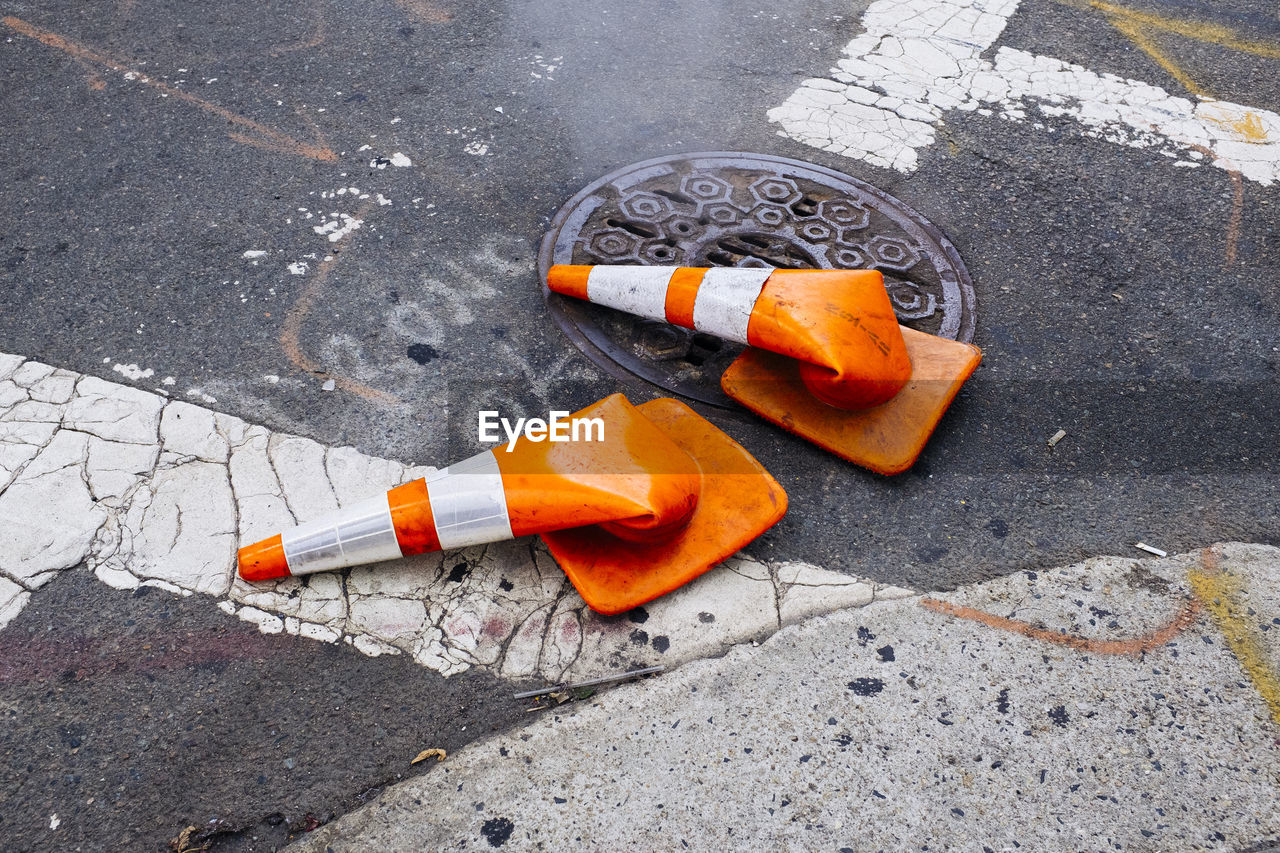 High angle view of broken traffic cones on road