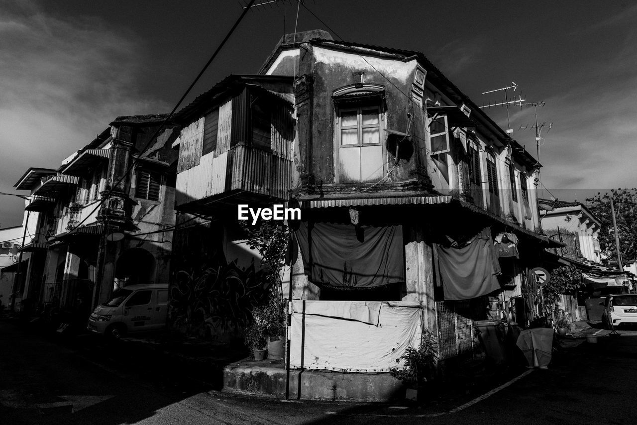 EXTERIOR OF ABANDONED BUILDING AGAINST SKY