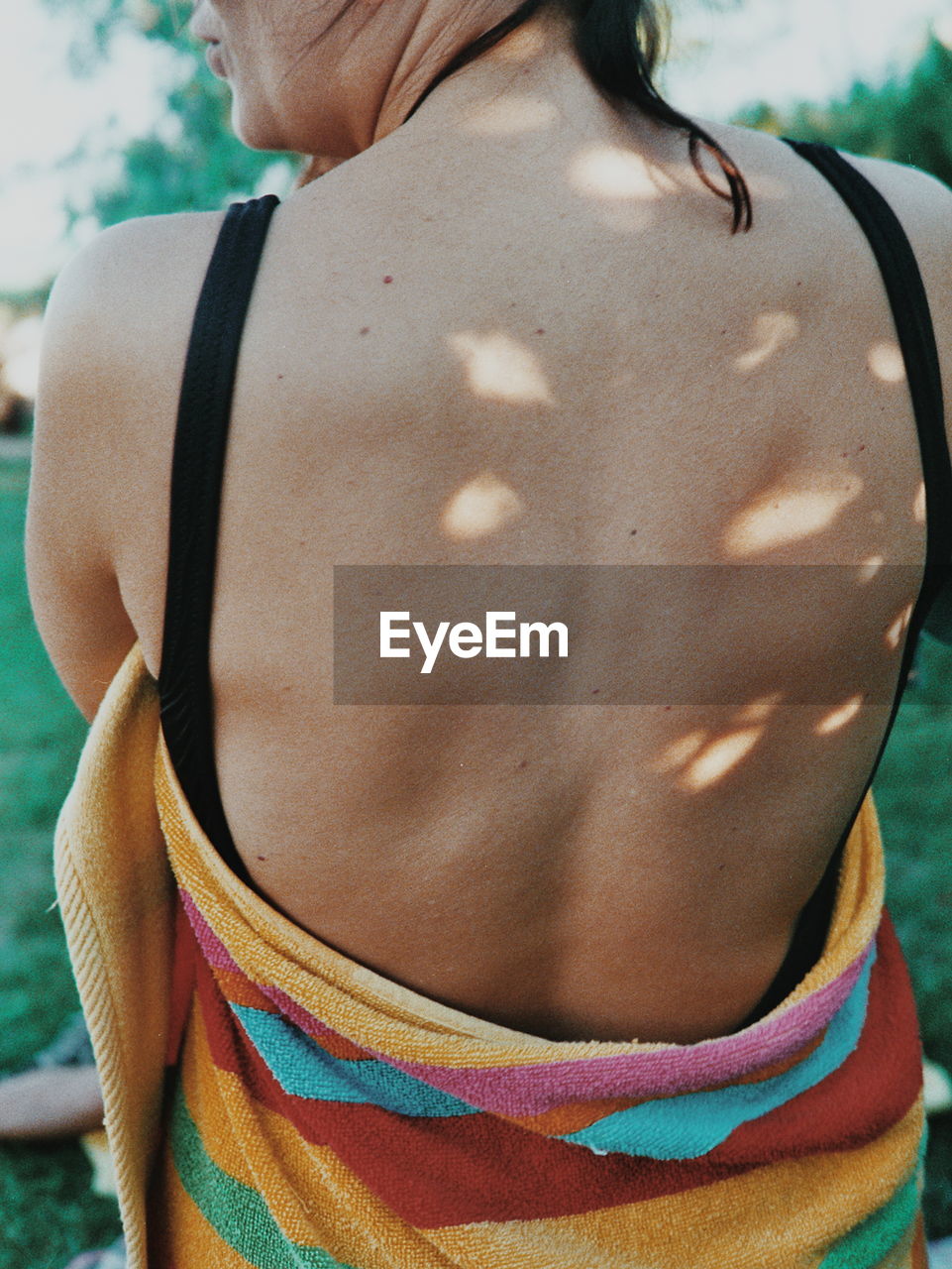 Rear view of woman in bikini standing outdoors