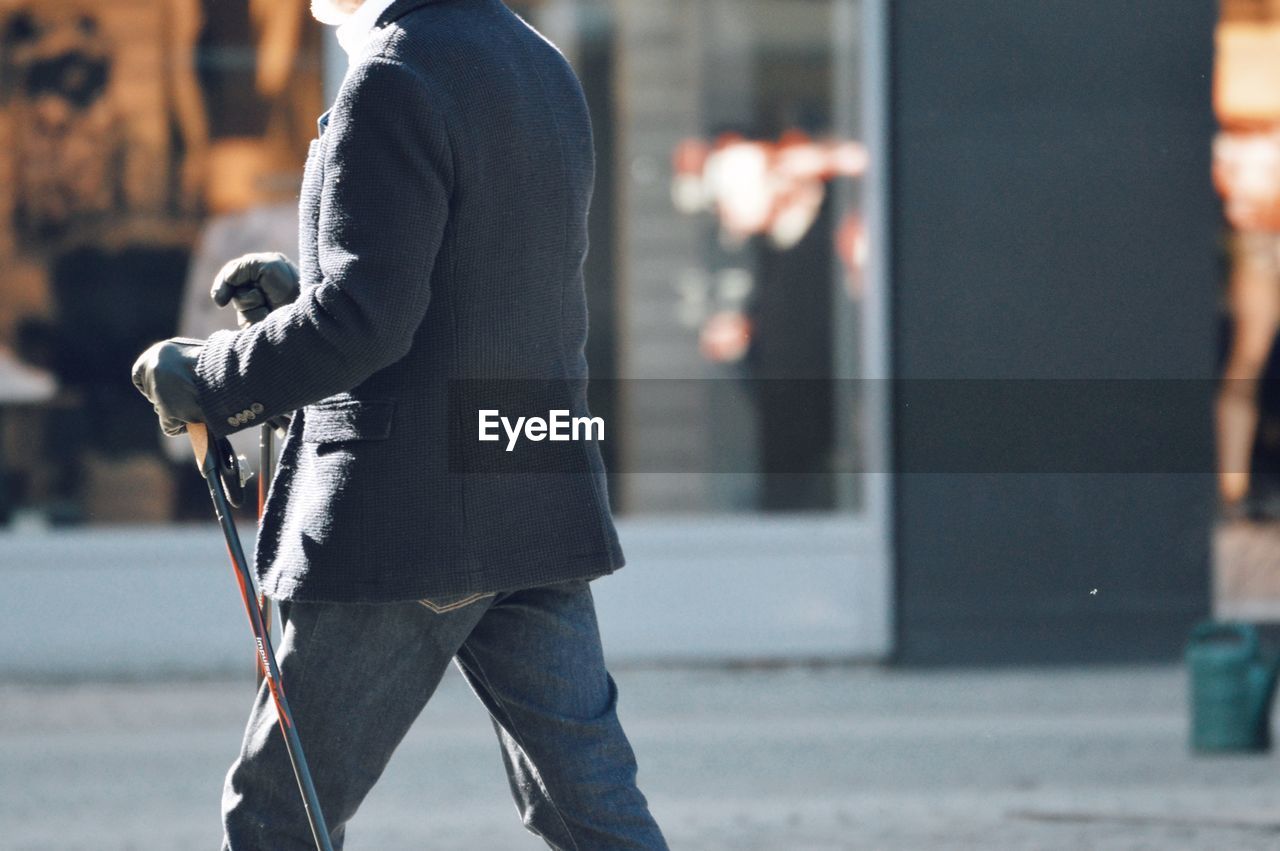 Rear view of man walking on street