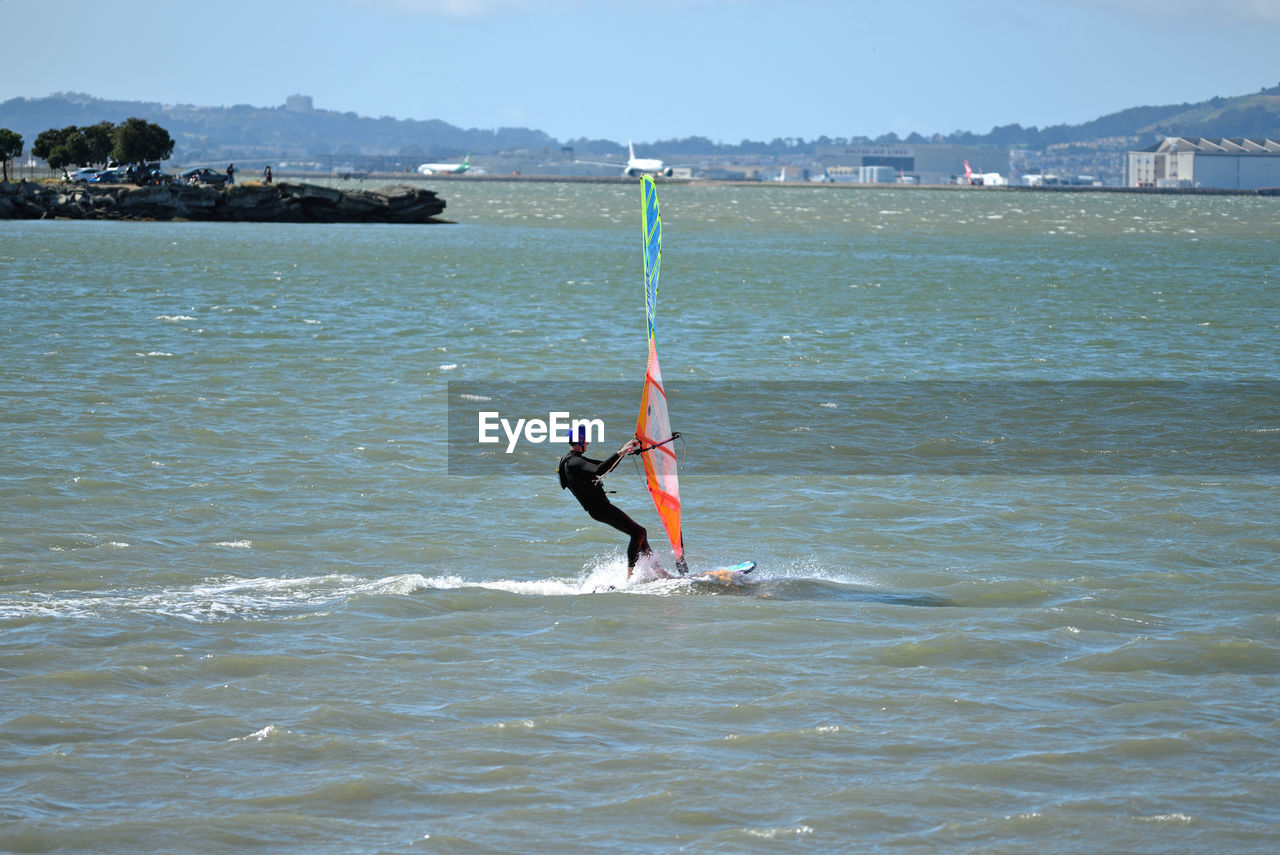 MAN SURFING ON SEA