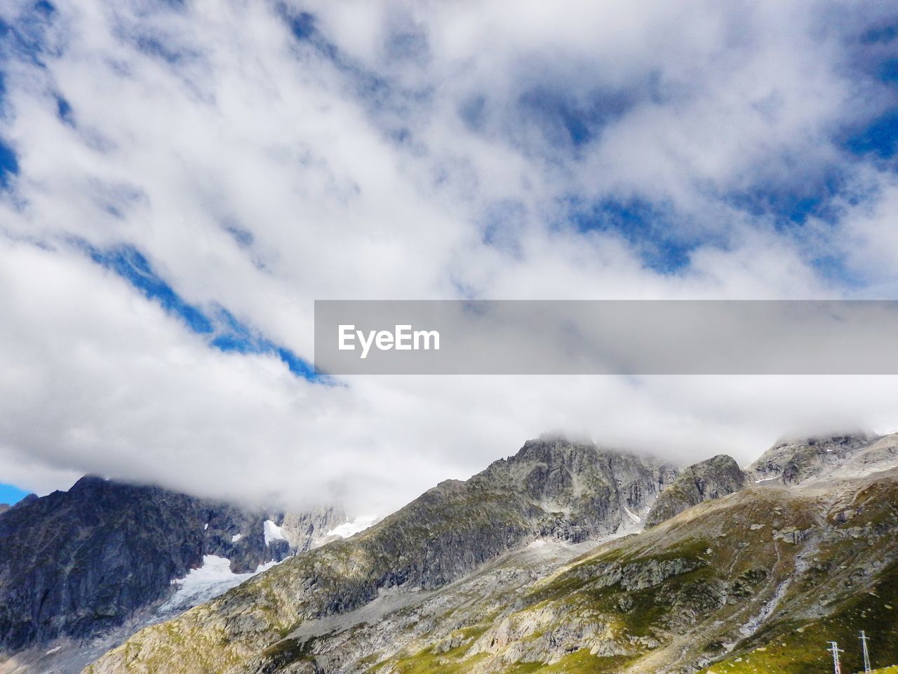 Low angle view of snowcapped mountains against sky