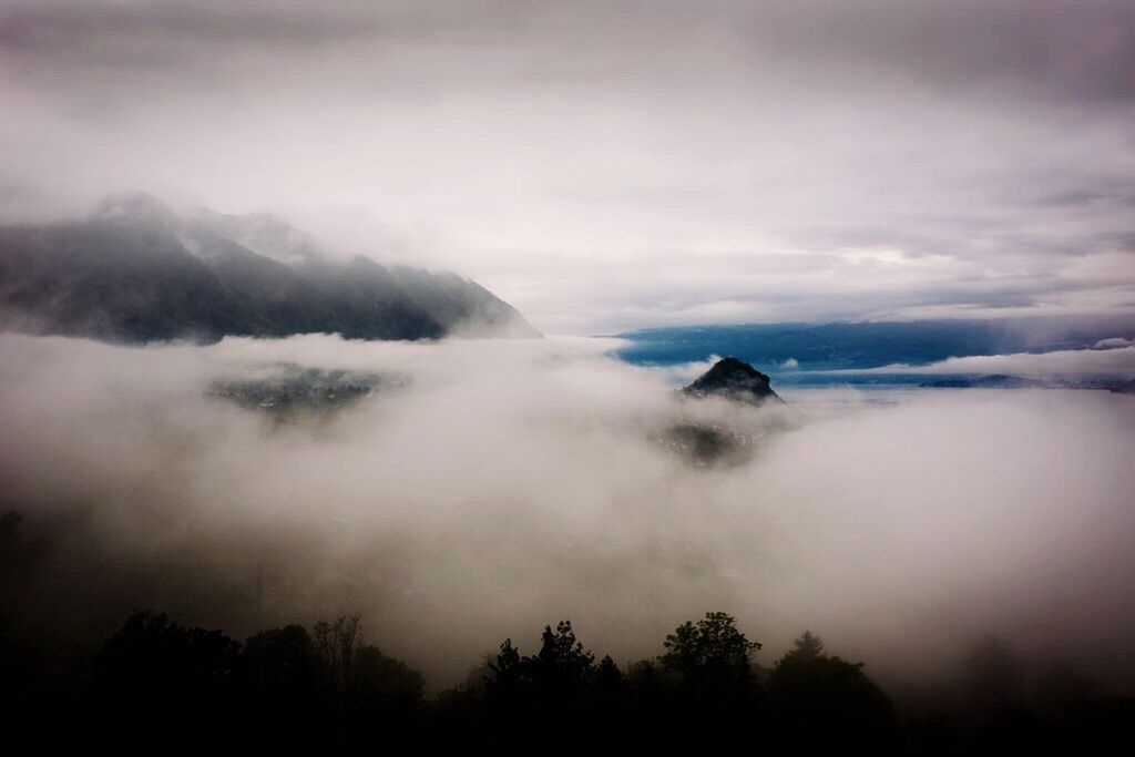 SCENIC VIEW OF MOUNTAINS AGAINST CLOUDY SKY