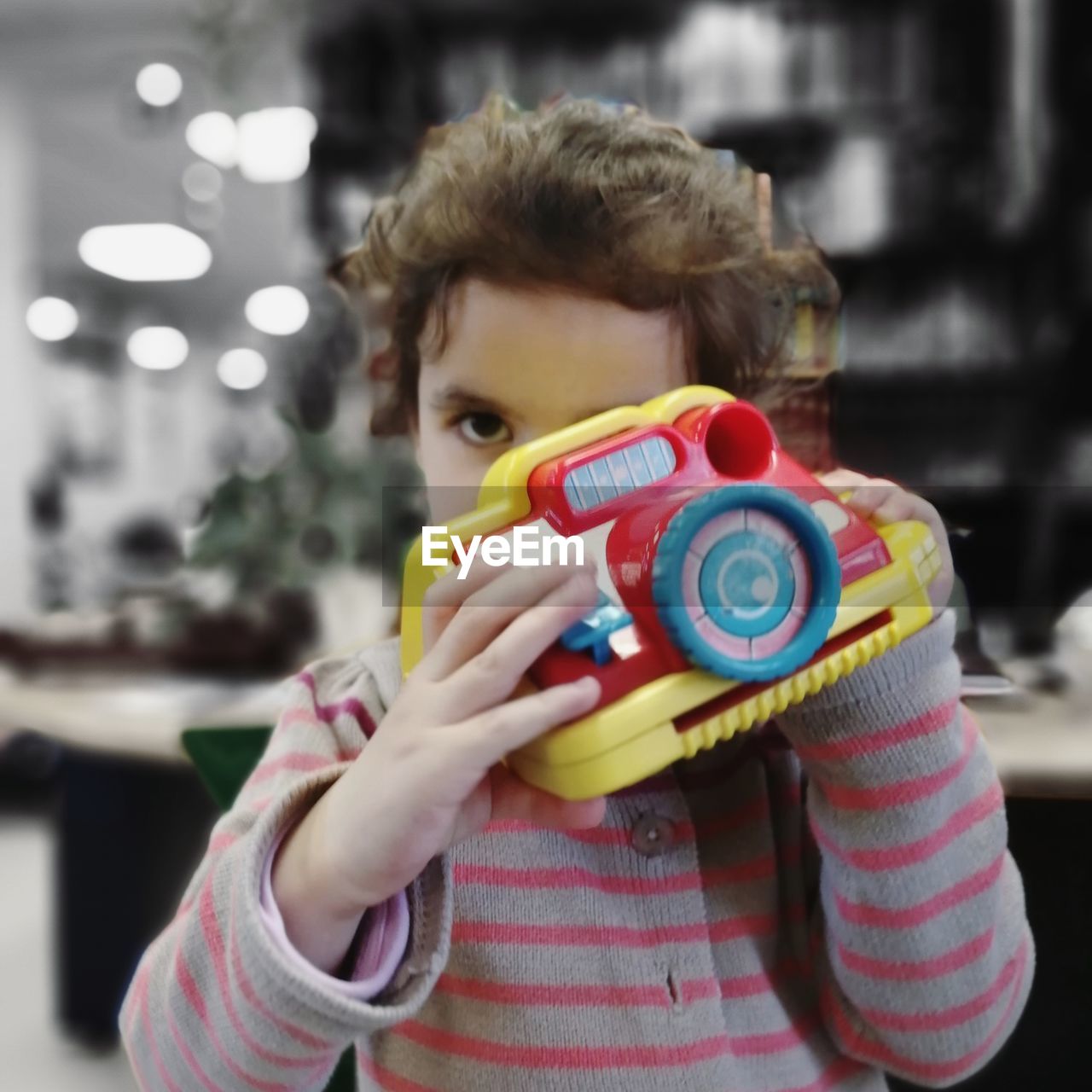 Portrait of girl holding toy camera