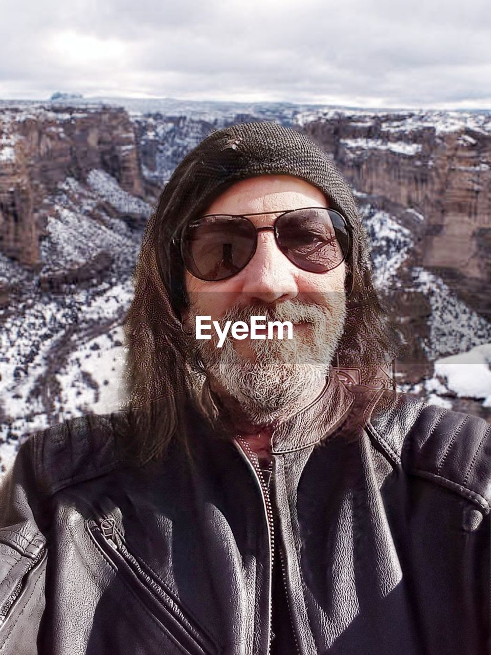 snow, winter, cold temperature, adult, portrait, one person, clothing, leisure activity, glasses, sunglasses, mountain, warm clothing, nature, cloud, front view, fashion, beard, facial hair, jacket, smiling, sky, looking at camera, men, mountain range, headshot, day, mature adult, lifestyles, holiday, vacation, person, scenics - nature, environment, trip, travel, outdoors, happiness, landscape, frozen, travel destinations, beauty in nature, hiking, adventure, emotion, sunlight, standing, spring, human face, ski holiday, land, goggles, non-urban scene, waist up, human hair