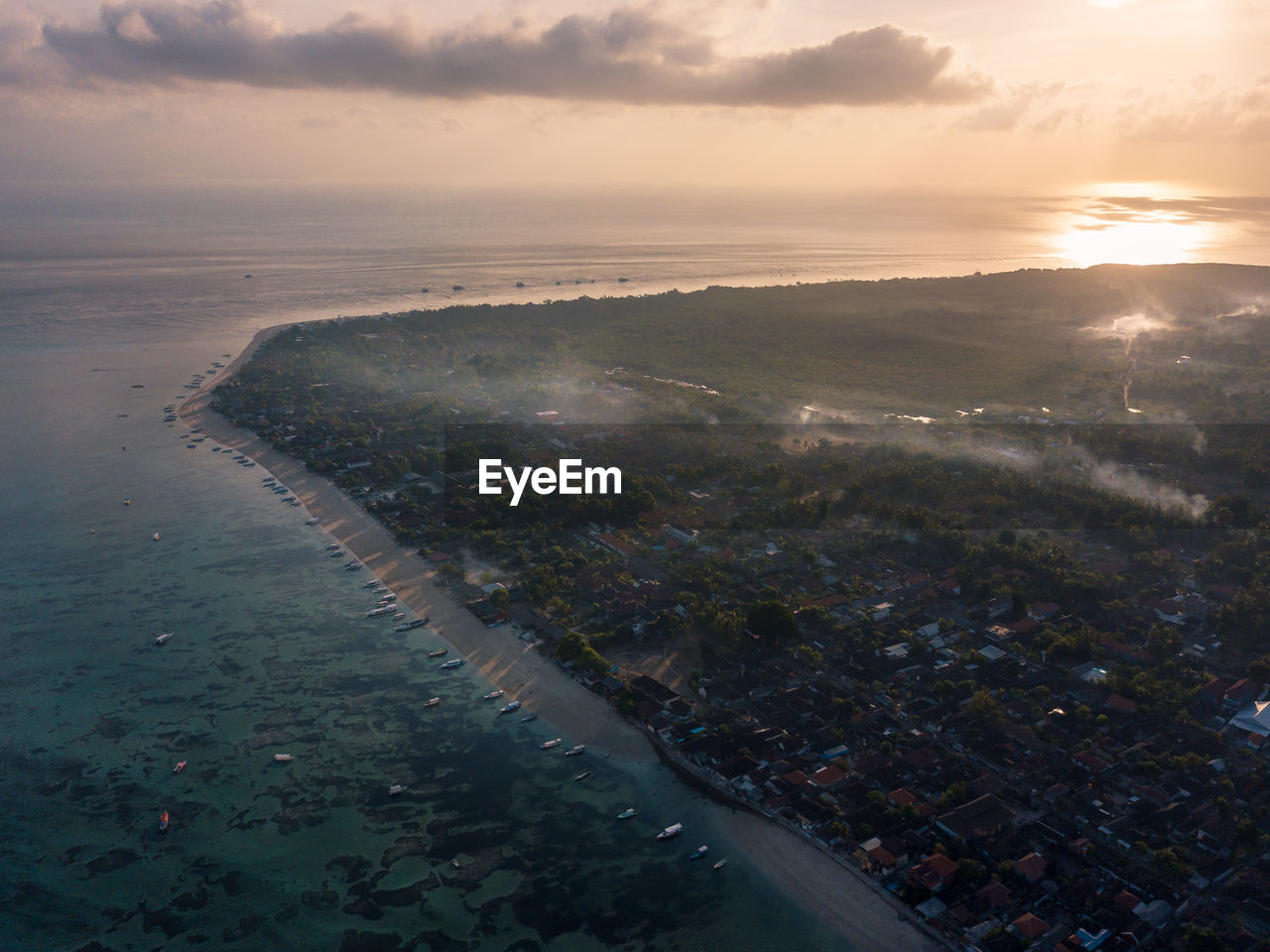 HIGH ANGLE VIEW OF CITY BY SEA AGAINST SKY