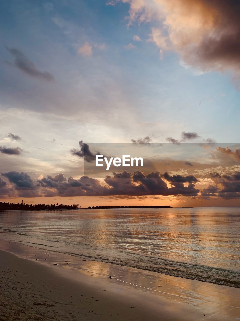 Scenic view of beach against sky during sunset