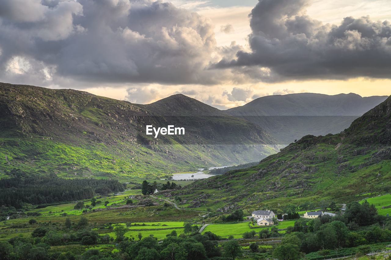 Small cottage surrounded by forest, lake and river in black valley. ring of kerry, ireland