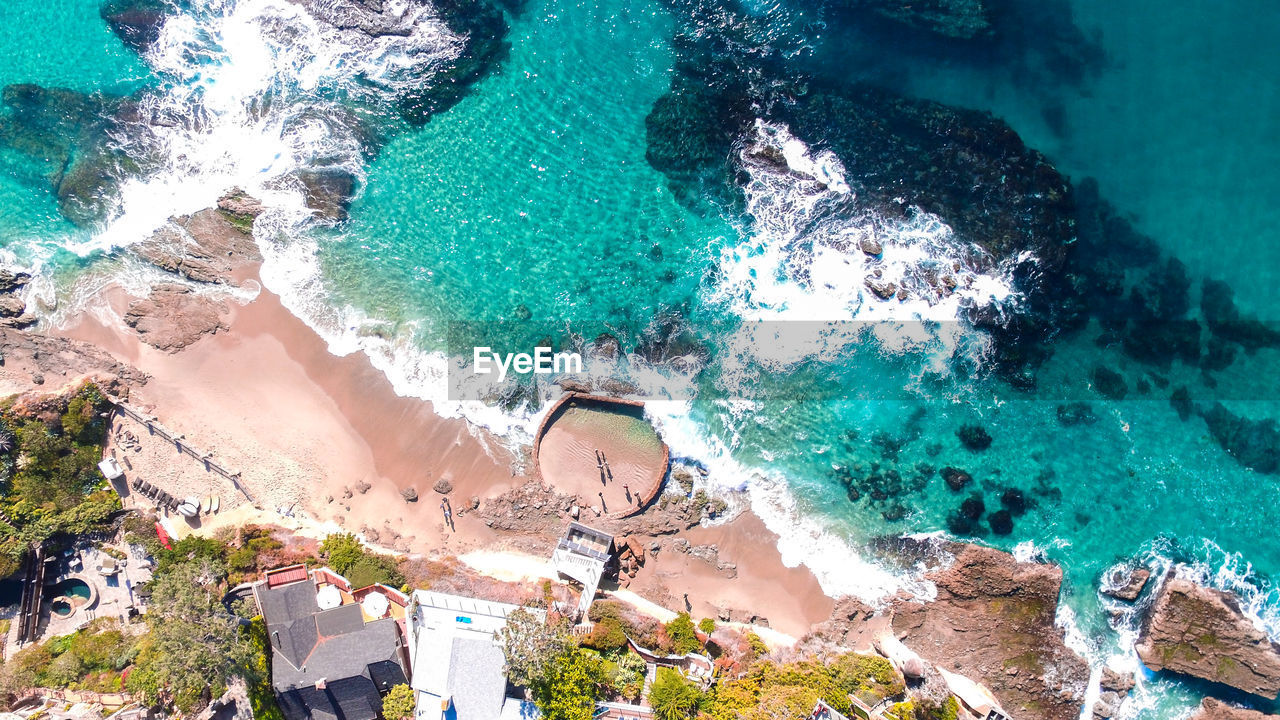 HIGH ANGLE VIEW OF SWIMMING POOL BY SEA