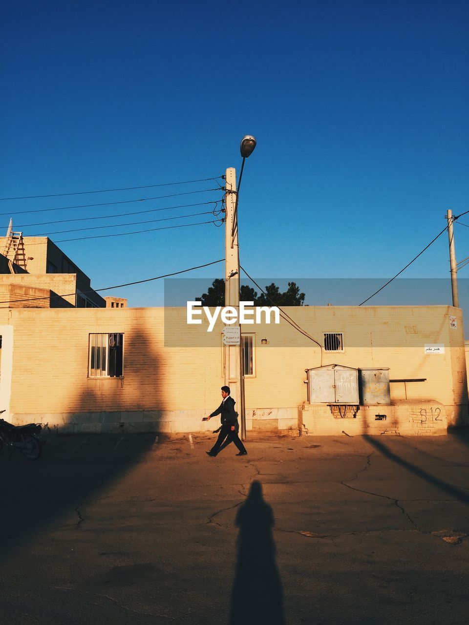 PEOPLE ON STREET AGAINST CLEAR SKY