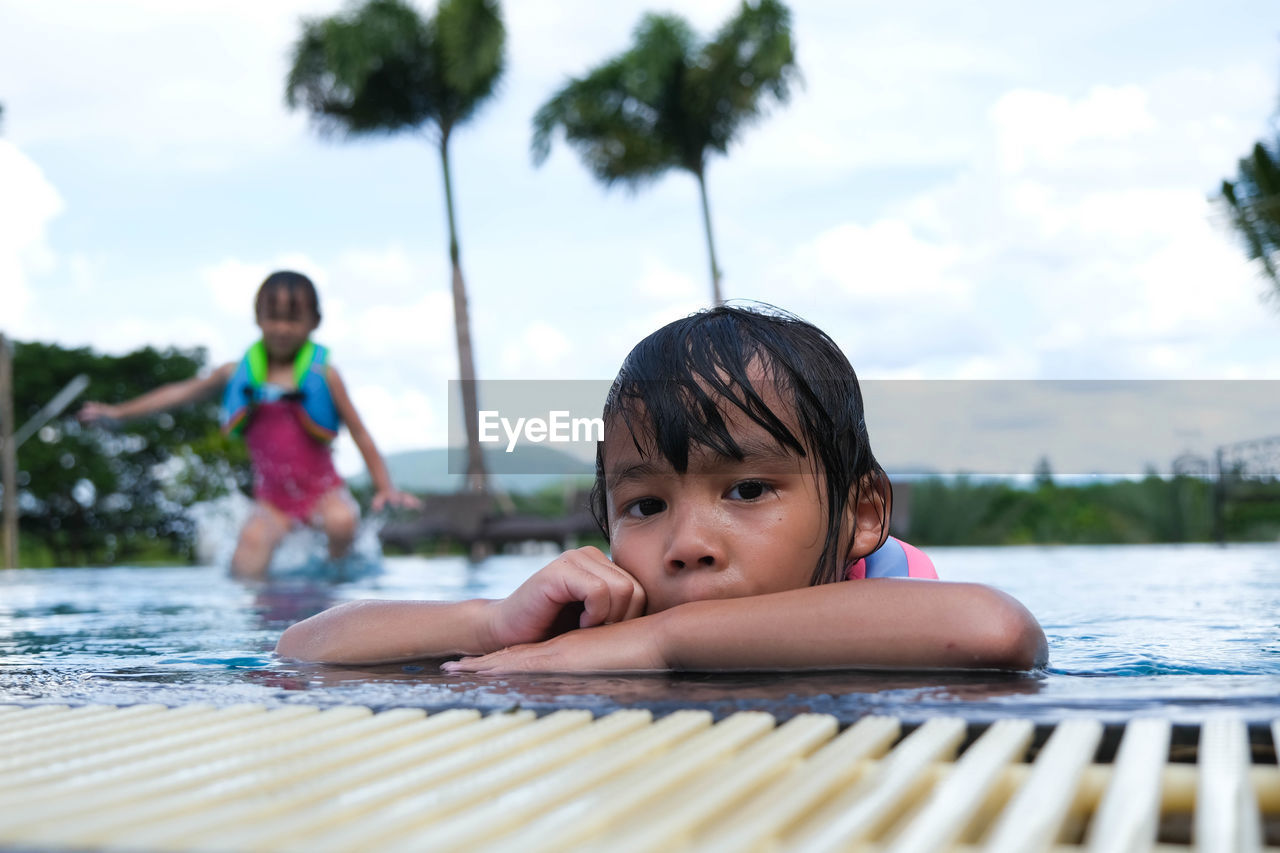 Portrait of boy swimming in pool