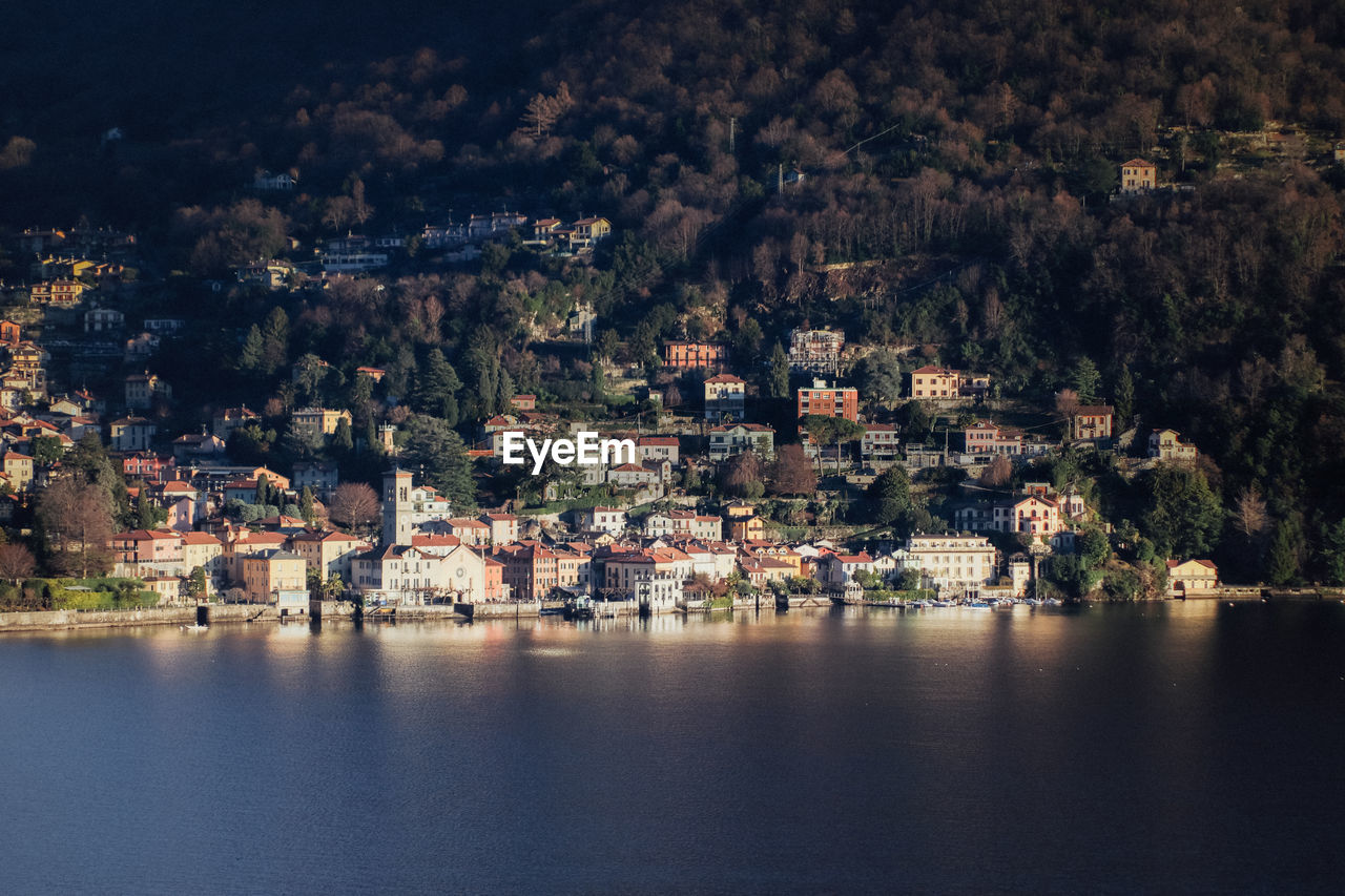 AERIAL VIEW OF TOWN BY SEA AGAINST BUILDINGS IN CITY