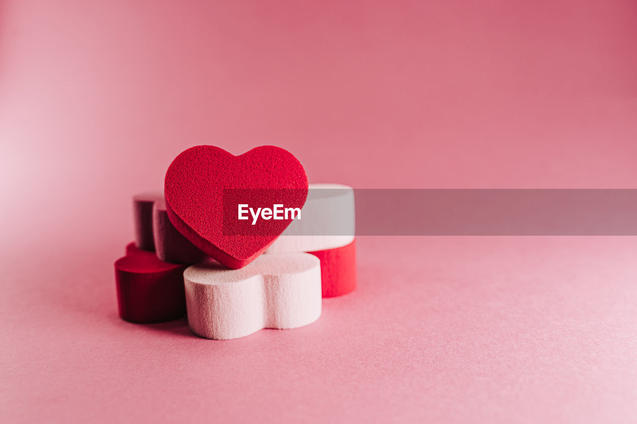 CLOSE-UP OF HEART SHAPE WITH PINK PETALS