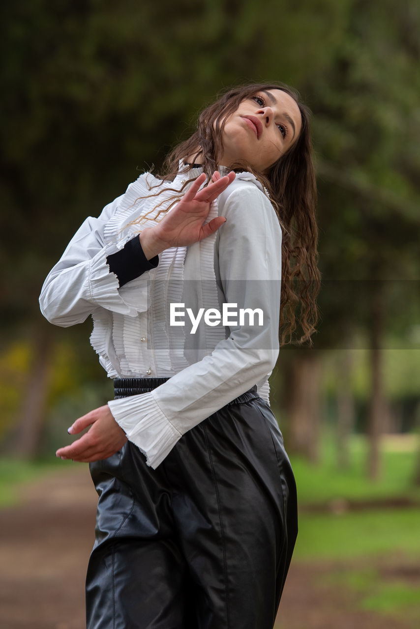 Young woman dancing outdoors. dance performance in the street