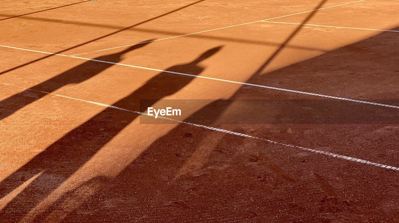 HIGH ANGLE VIEW OF SHADOW OF PERSON ON THE FLOOR