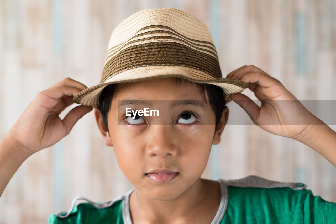 Close-up of boy wearing hat