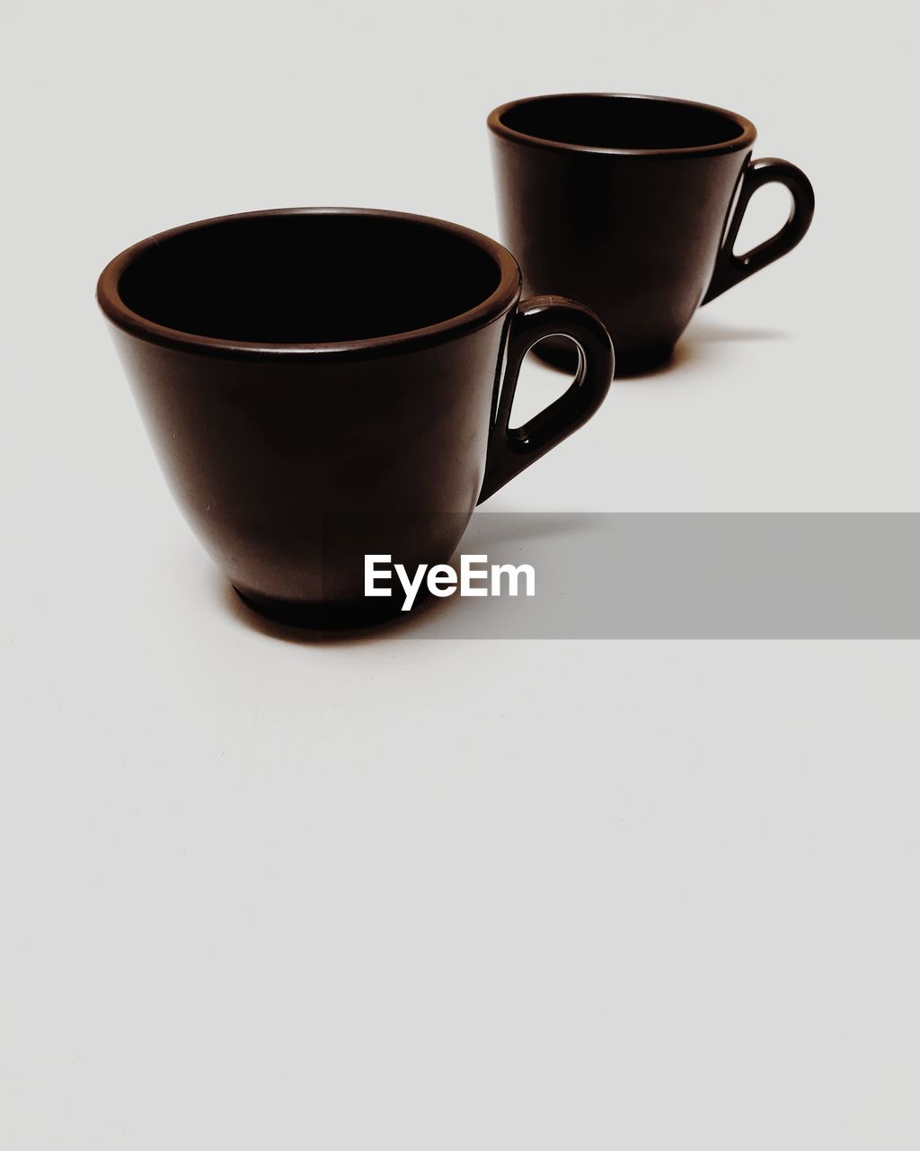 Close-up of coffee cups against white background
