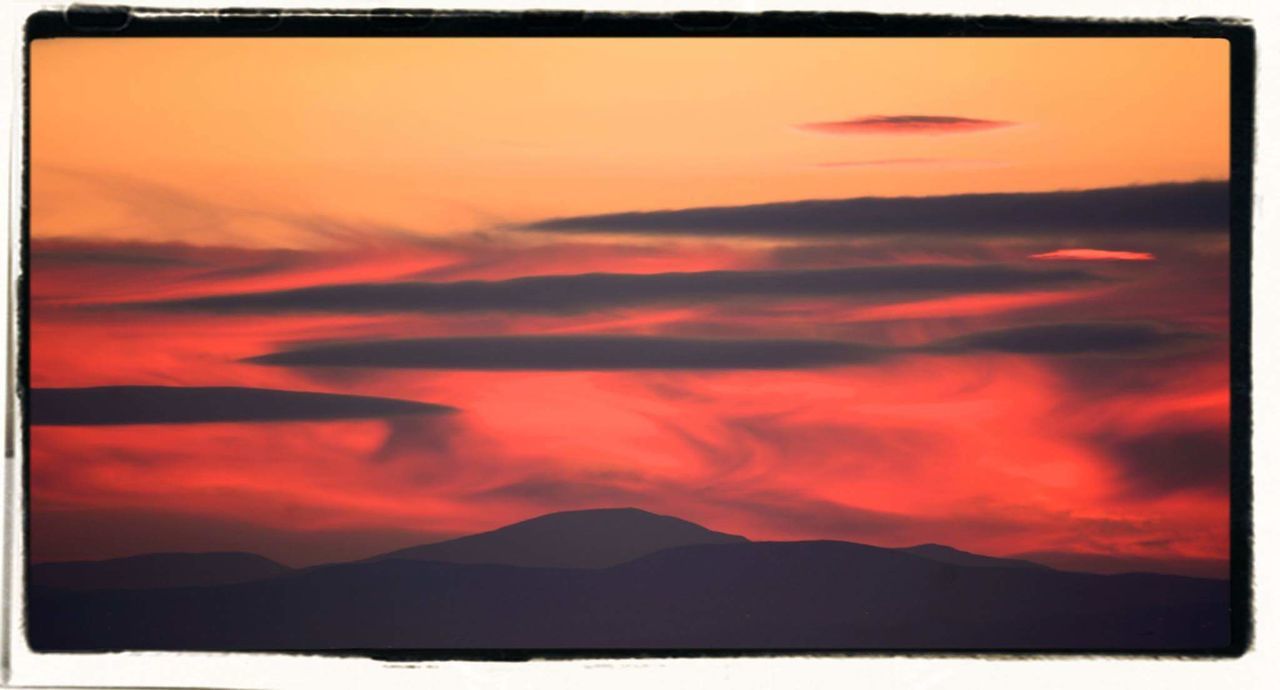 SILHOUETTE OF MOUNTAIN AT SUNSET