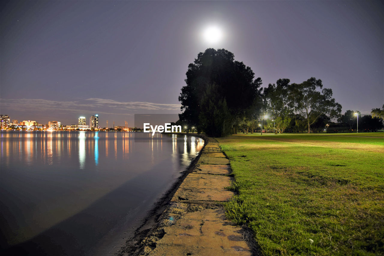 Scenic view of illuminated park against sky at night