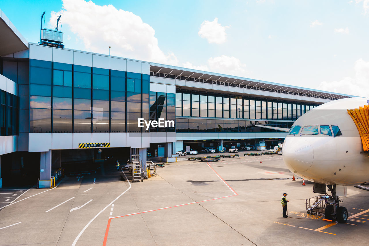 low angle view of airplane on airport runway against sky