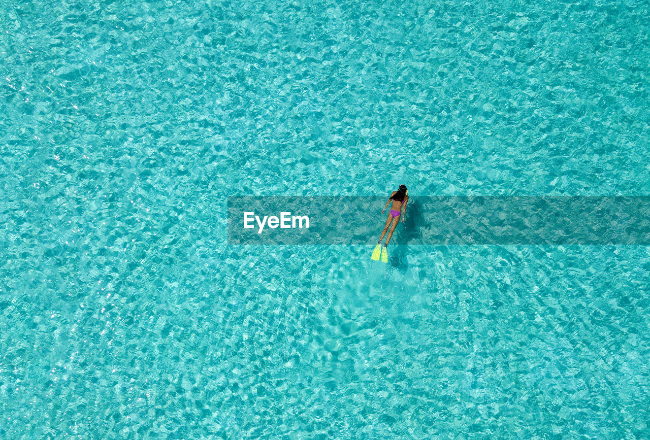 High angle view of woman swimming in sea