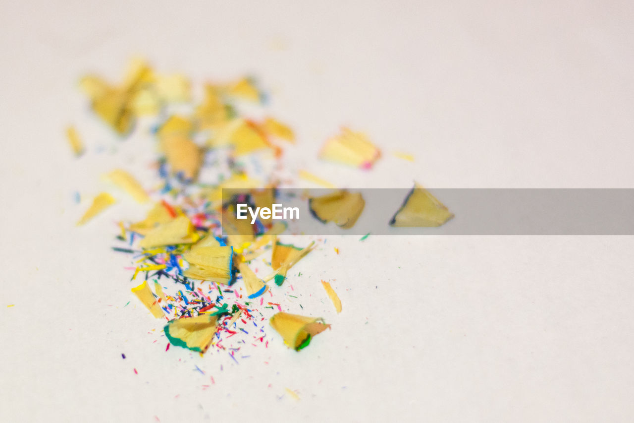 Close-up of pencil shavings against white background