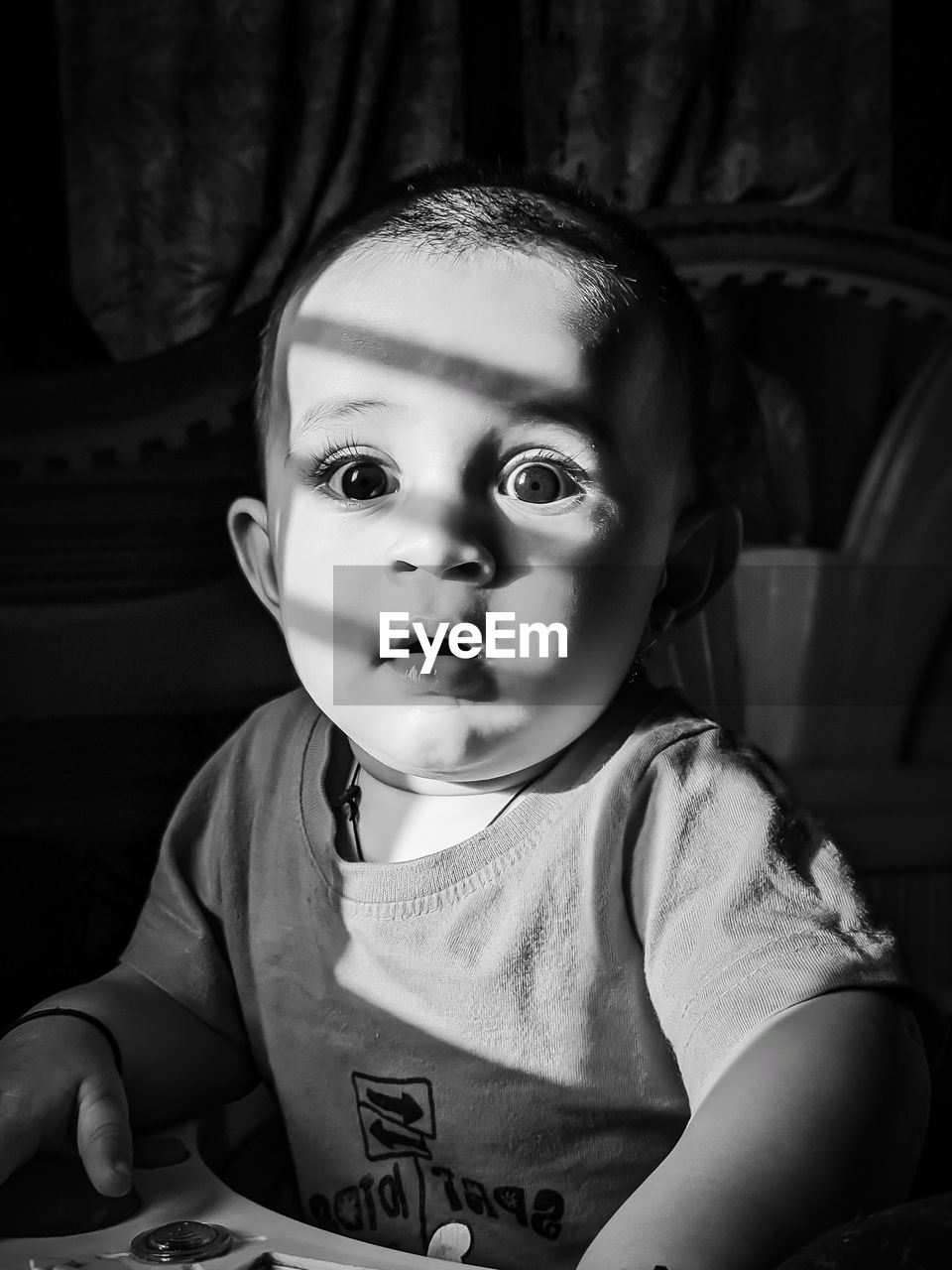 Portrait of cute baby boy sitting at home