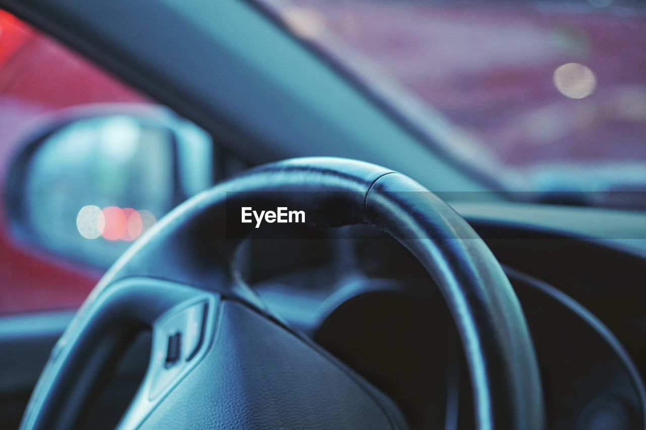 Close-up of steering wheel in car