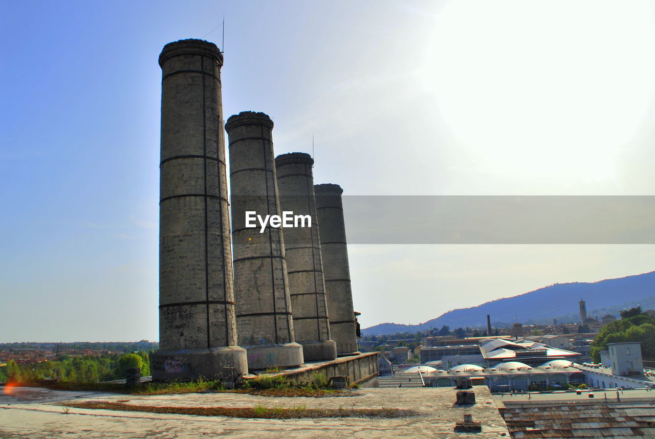 SMOKE STACKS AGAINST SKY