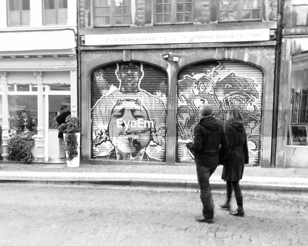 WOMAN STANDING IN CITY