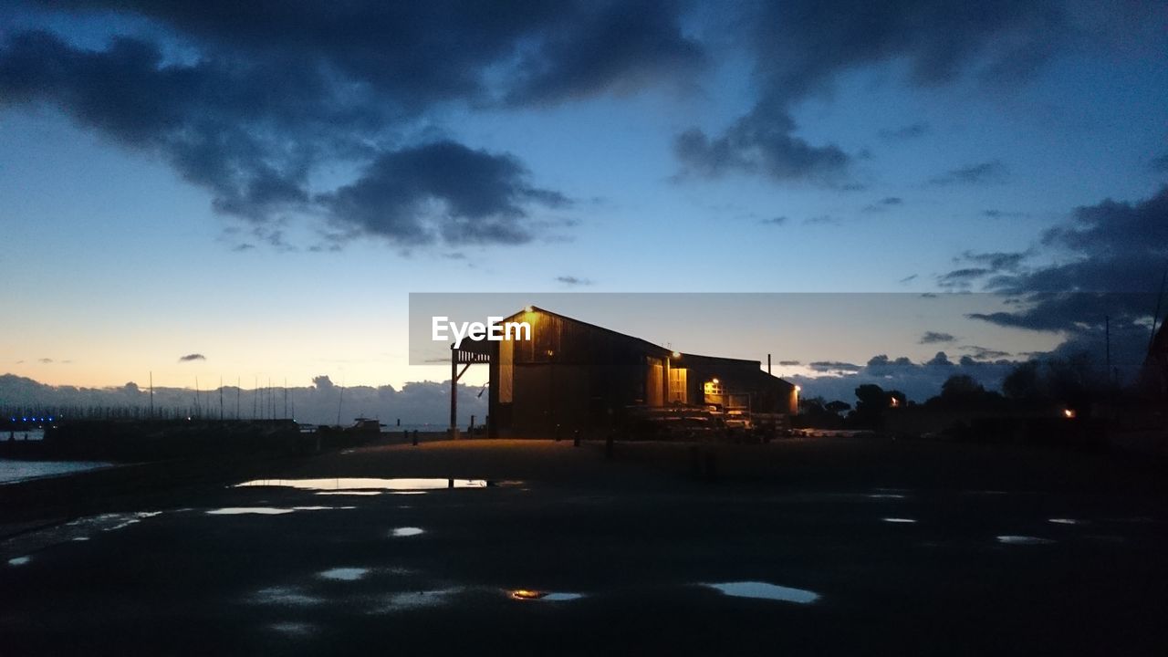 Silhouette built structure against blue sky