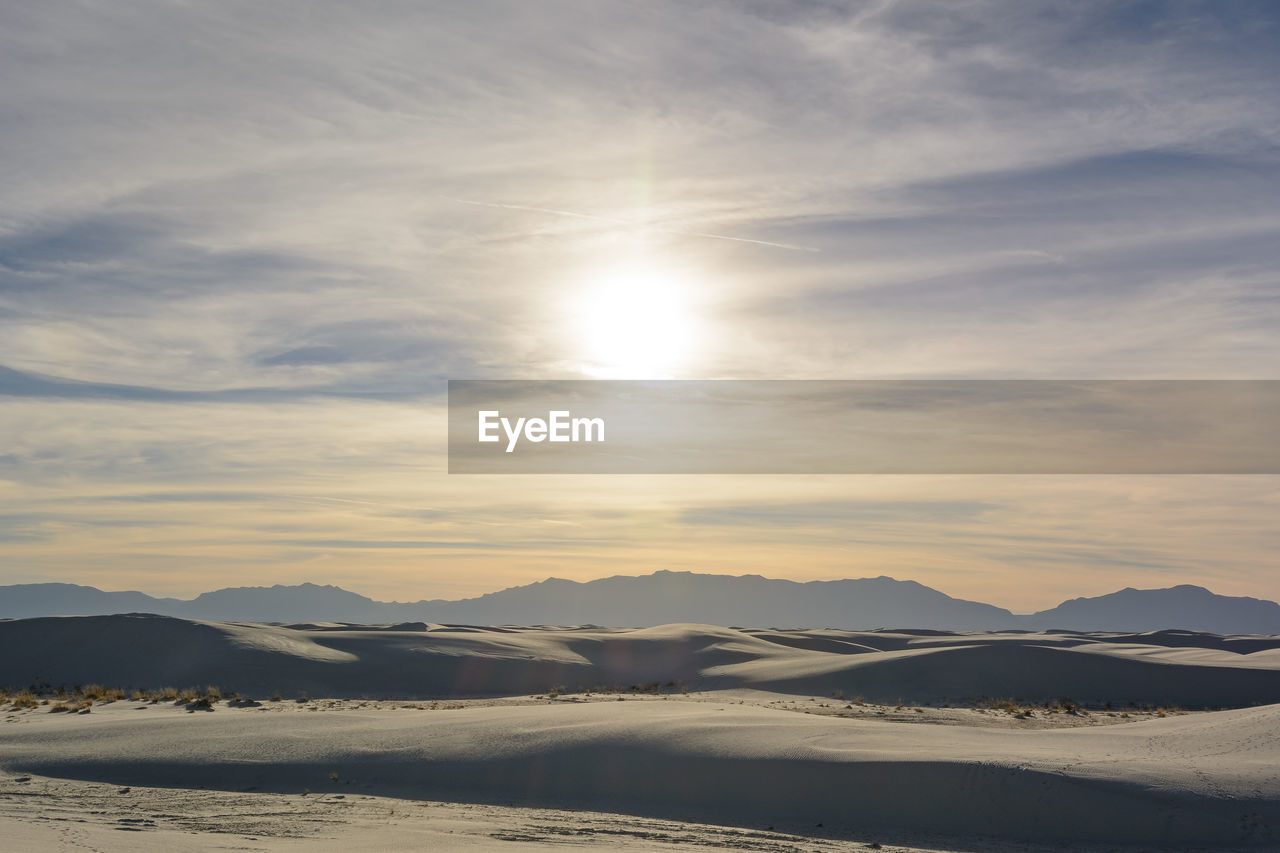 Scenic view of sand dunes during sunset