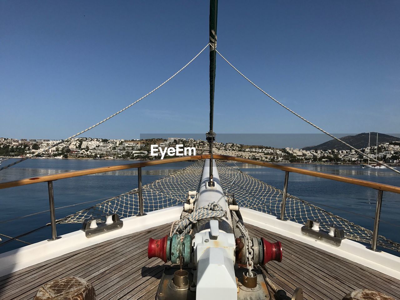 Boat sailing on sea against clear sky