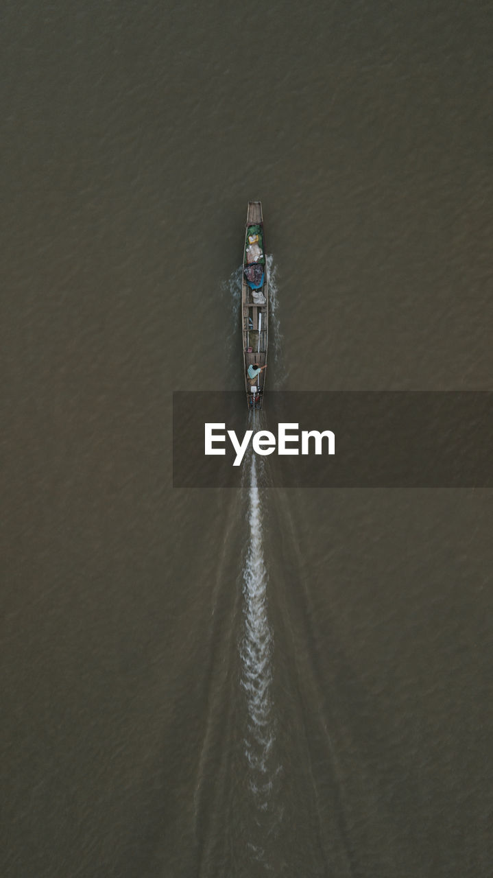 Aerial view of boat sailing at river