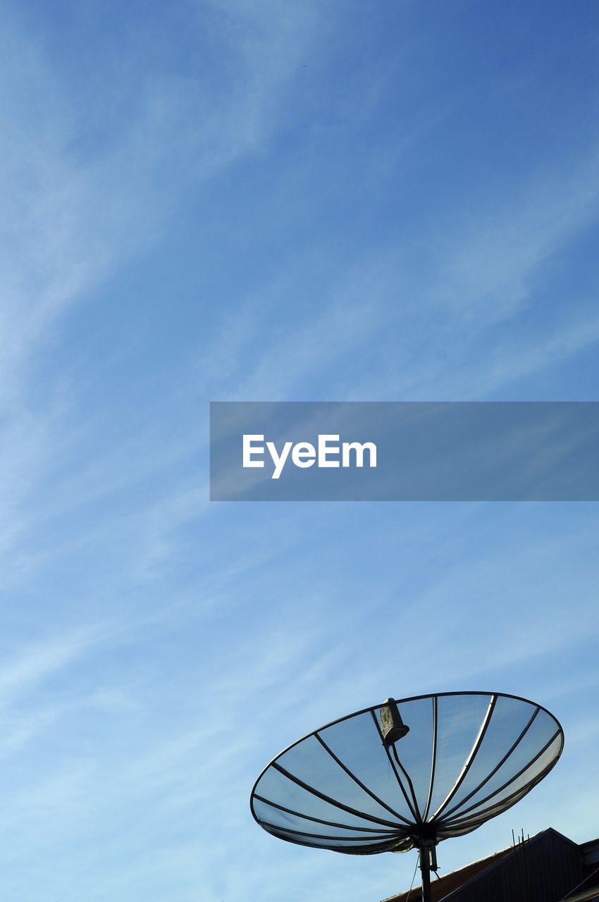 Low angle view of communications tower against blue sky