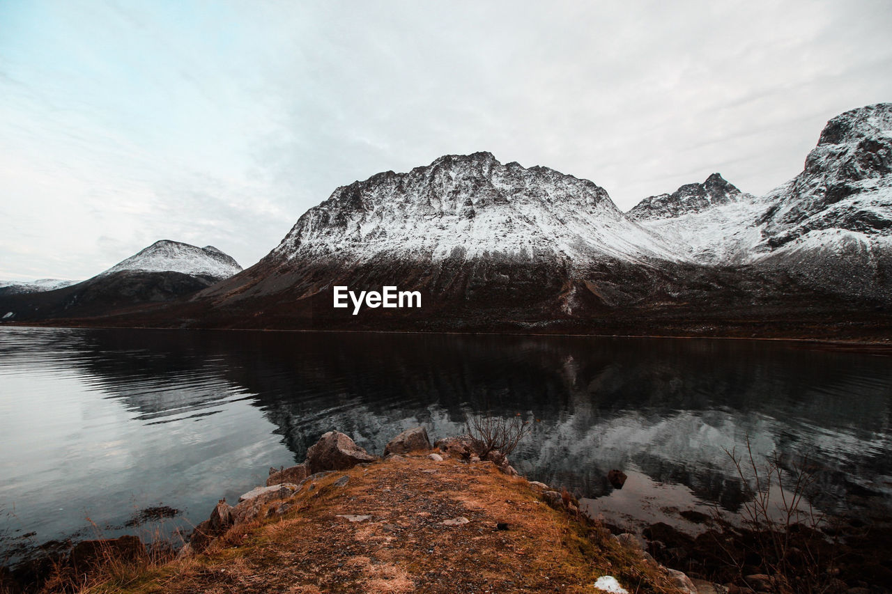 Scenic view of lake and mountains against sky