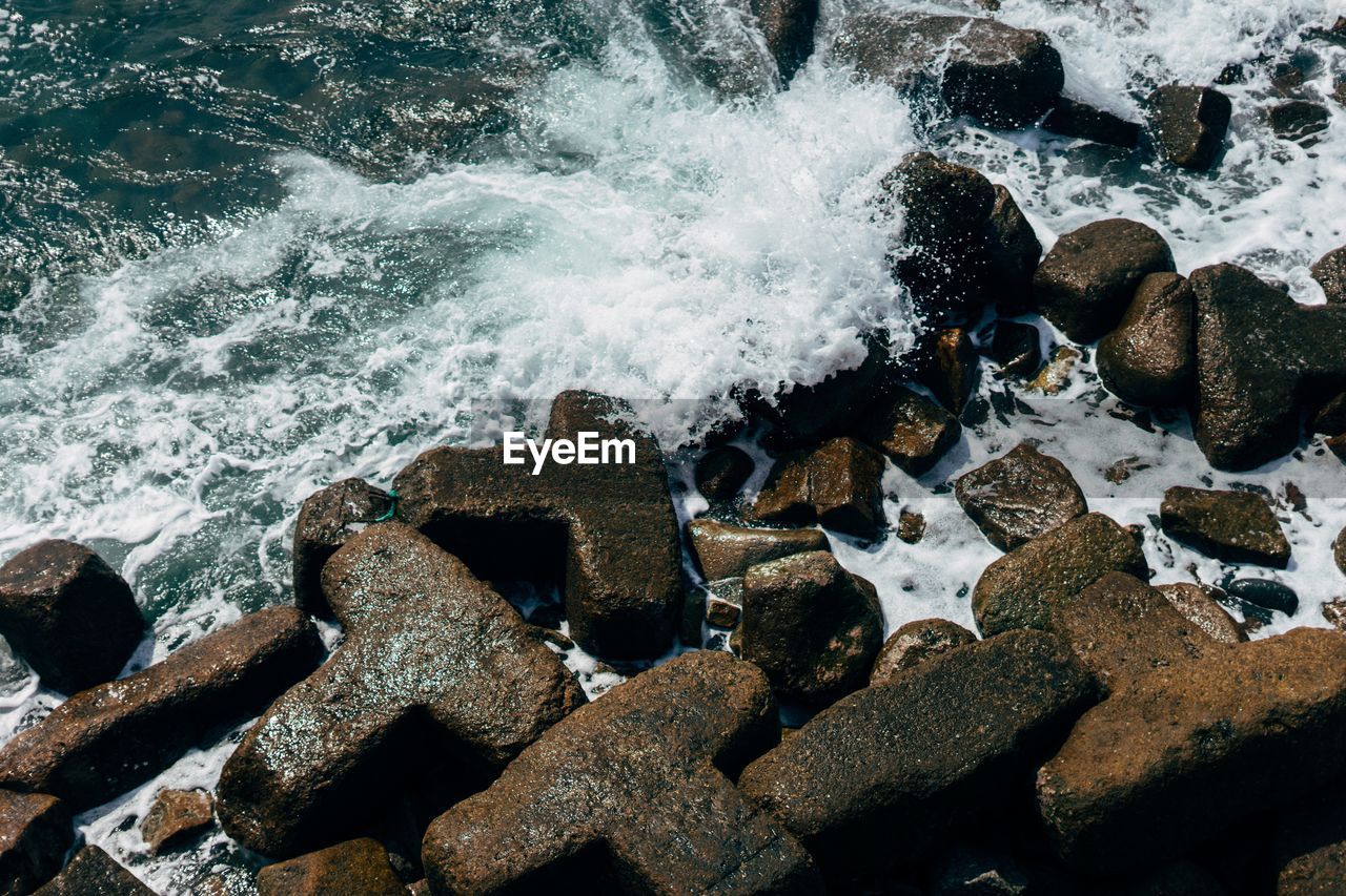 View of waves splashing on rocky beach