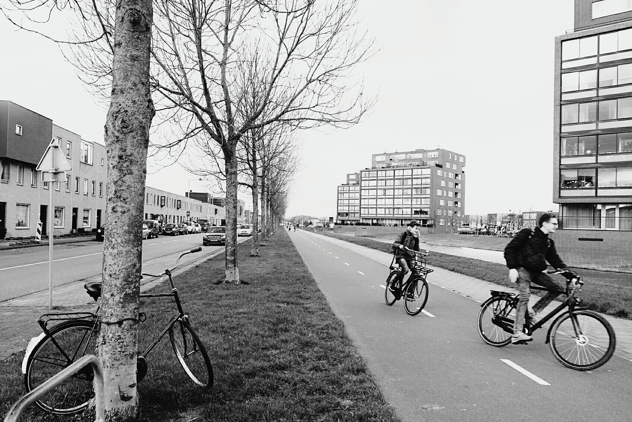 MAN RIDING BICYCLE ON STREET