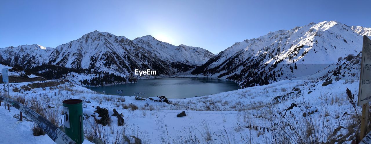 Scenic view of snowcapped mountains against clear sky