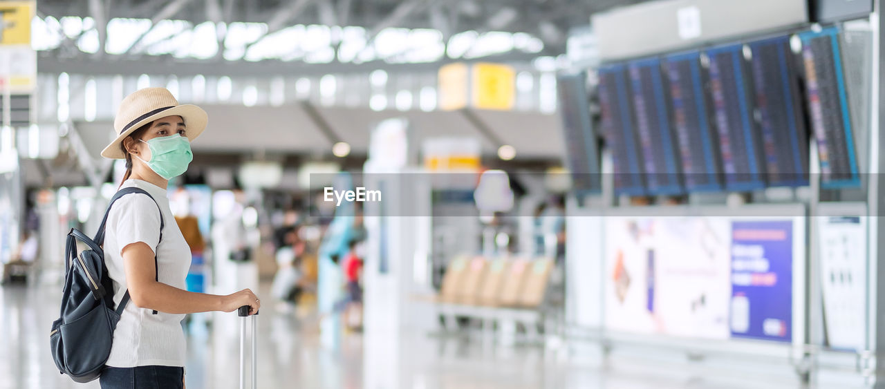 Beautiful woman with mask in airport