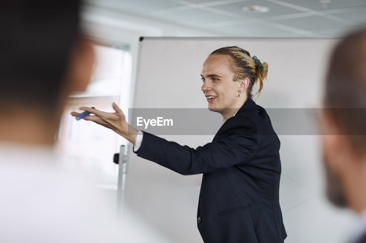 Smiling man having presentation at meeting