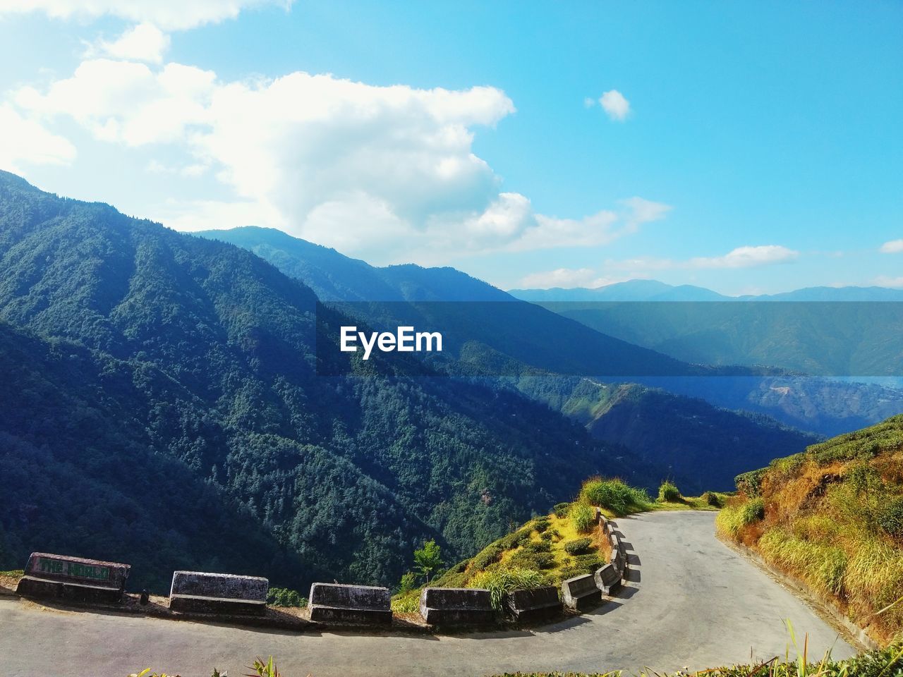 HIGH ANGLE VIEW OF ROAD AMIDST MOUNTAINS AGAINST SKY