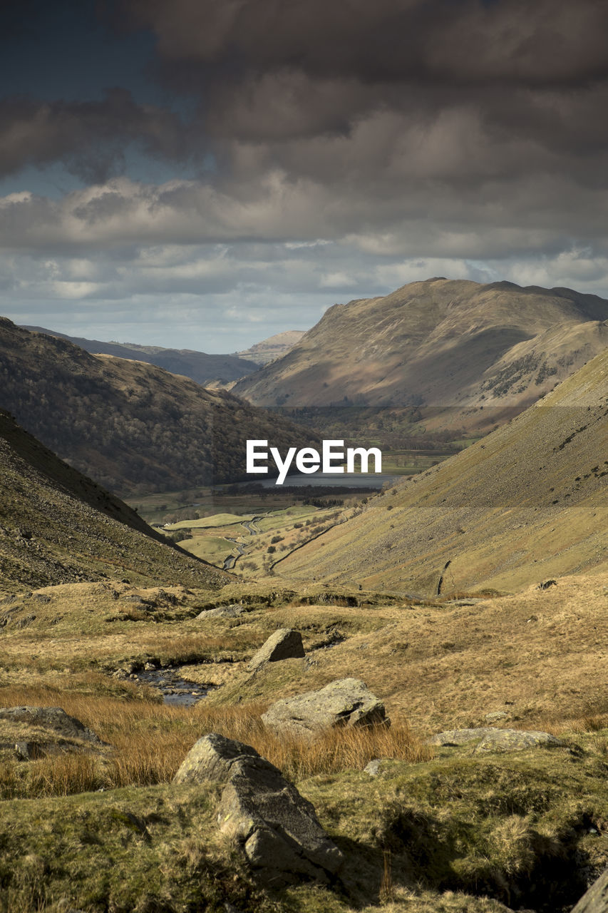 Scenic view of honister pass against cloudy sky