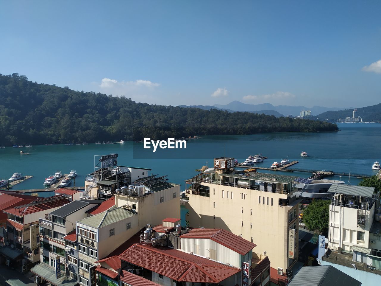 High angle view of buildings by sea against sky